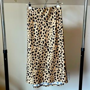 This satin midi skirt is hand sewn with a hidden elastic waistband, fits a M/L.